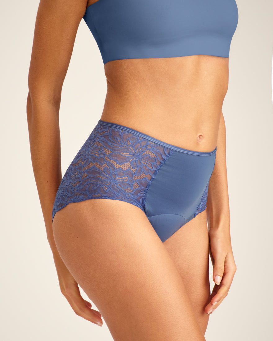 Modell trägt ooia Highwaist Lace Extra Strong in Smoky Blue – elegante Periodenunterwäsche mit hohem Spitzenbund und Spitzeneinsätzen.