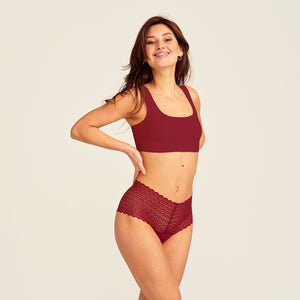 Modell trägt ooia Periodenunterwäsche Highwaist Comfy Lace in merlot, mit durchgängiger, elastischer Spitze.