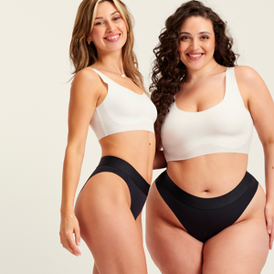 Zwei Models unterschiedlicher Konfektion tragen ooia Slip Seamless Cheeky in Schwarz – nahtlose Periodenunterwäsche mit hohem Beinausschnitt