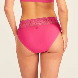 Modell trägt ooia Slip Extra Strong in hot pink mit Spitze am Bund – Periodenunterwäsche für starke Tage, Rückansicht