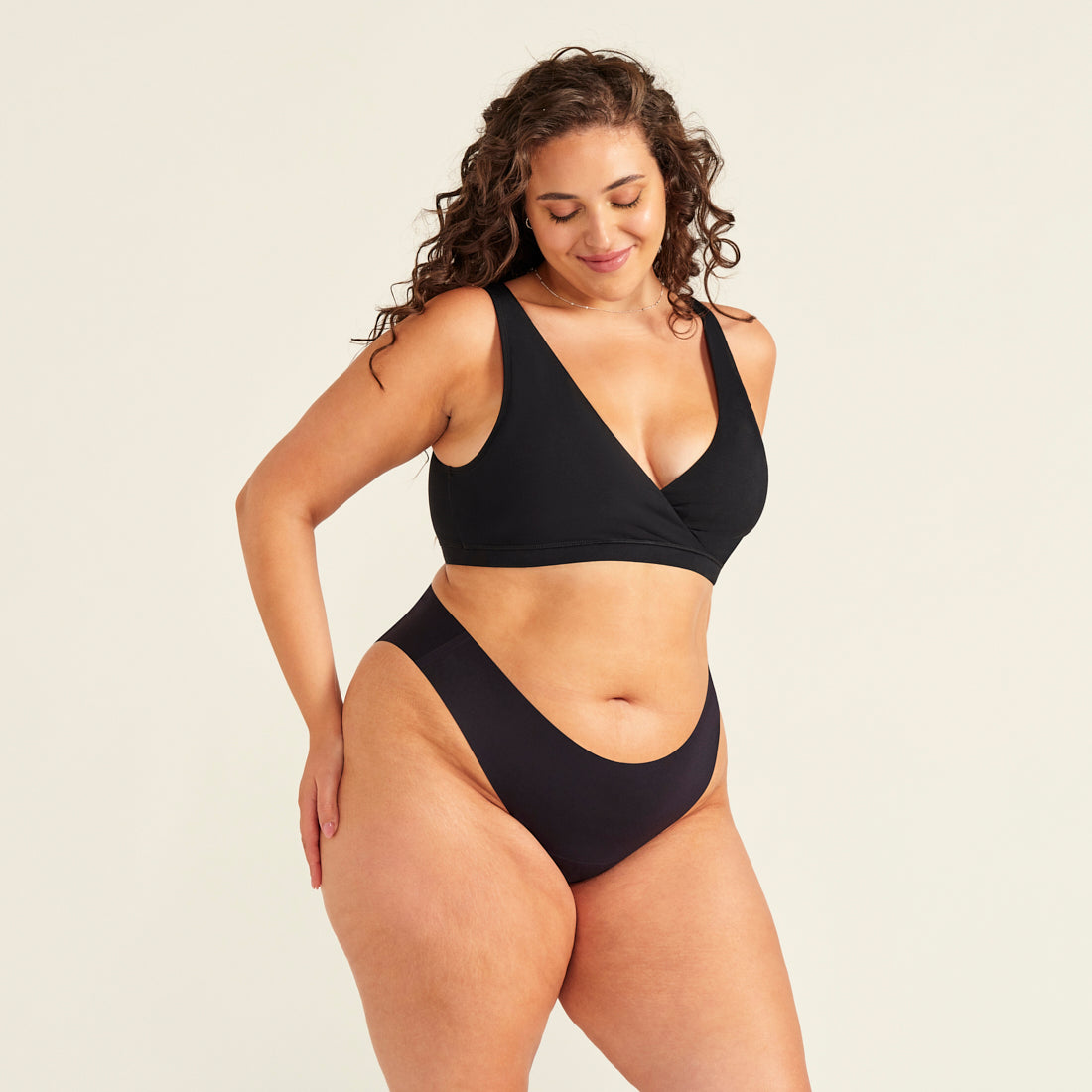 Frau in nahtlosem schwarzem Perioden Slip und Moms Still BH mit Pull-Down Funktion